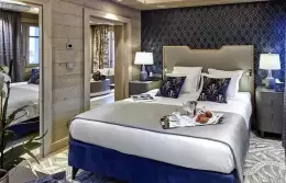 Junior Suite 1 bedroom with a navy bed base and patterned wallpaper, Lys Martagon, Courchevel 1850