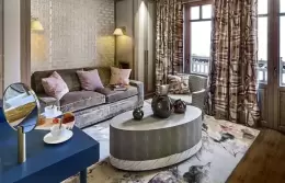 Junior Suite 1 bedroom with a navy bed base and patterned wallpaper, Lys Martagon, Courchevel 1850