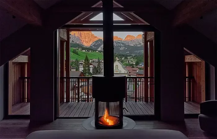 Room fireplace with a view of village and mountains.