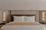 Bed in a bright superior suite at Aman Rosa Alpina.