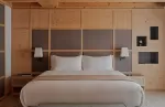 Wooden Zeno suite bedroom at Aman Rosa Alpina hotel.
