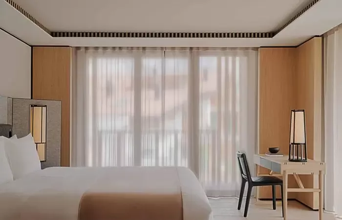 Bedroom in a deluxe suite at Aman Rosa Alpina.