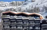 Exterior of chalet Cristal in the snowy mountains of Val d-Isere.