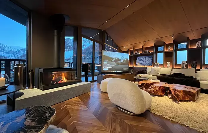 Living room with a fireplace in chalet Cristal in Val d-Isere