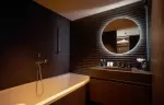 Bathroom with bathtub and backlit round mirror at Fahrenheit Seven Les Menuires