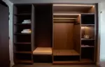 Open dressing room with shelves, hanging space and bench at Fahrenheit Seven Les Menuires