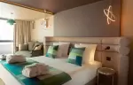 King-size bed with cocoon headboard in a room at Fahrenheit Seven Les Menuires