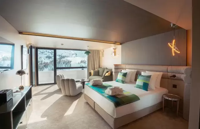 Hotel room with panoramic window and mountain view at Fahrenheit Seven Les Menuires