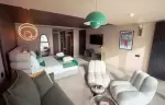 Suite with king-size bed and lounge seating at Fahrenheit Seven Les Menuires