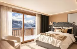 Duplex Suite bedroom with floor-to-ceiling windows onto a balcony at Barma, Courchevel La Tania