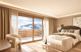 Bedroom with a fireplace in the Master Suite half of the Alpine Suite at Barma, La Tania
