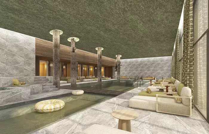 Long indoor pool with slender columns and day beds at Barma Hotel & Spa, Courchevel La Tania