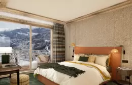 Bedroom with a terracotta headboard and a window onto the mountains in a Deluxe Cabin Apartment, Barma Residence