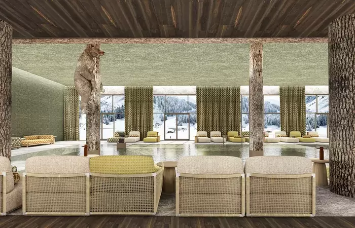 Indoor pool with a carved wooden bear and loungers facing the snow at Barma, La Tania