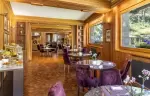 The breakfast room with purple chairs at Hotel Hermitage, Breuil-Cervinia