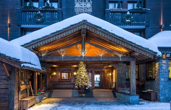 The snowy entrance porch with a Christmas tree at Hotel Hermitage, Breuil-Cervinia