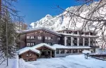 The hotel facade in deep snow on a sunny day, Hotel Hermitage, Breuil-Cervinia