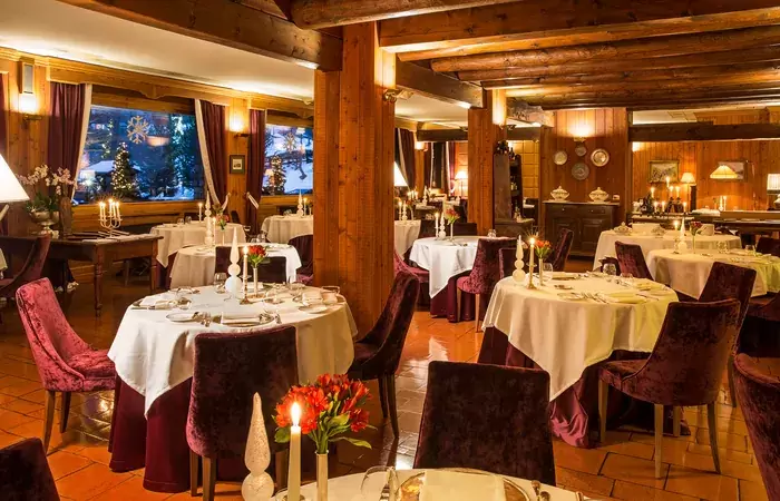 Laid tables in the La Chandelle dining room at Hotel Hermitage, Breuil-Cervinia