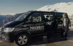 A skier and a man beside the No. 14 chalet van in Verbier