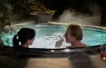 Two guests in the steaming outdoor hot tub at No. 14 Verbier